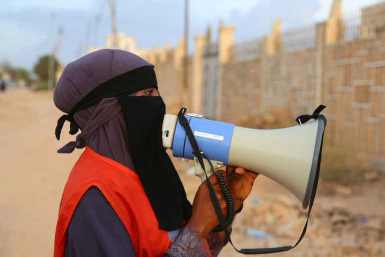A member of the volunteer vaccination team makes an announcement  for residents in Hargeisa to bring out their children for oral polio vaccine during the national immunization campaign in Hargeisa, Somaliland on 26 March 2019. WHO Photo.